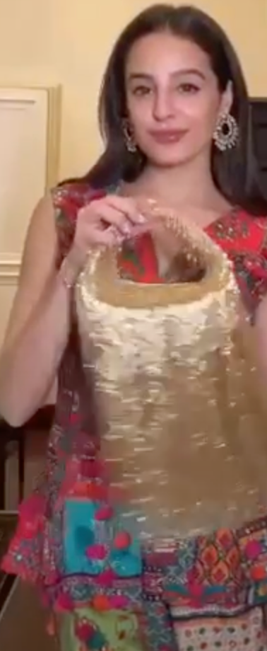 Tarini in our Golden Embellished Zaha Tasselled Cutdana Bag
